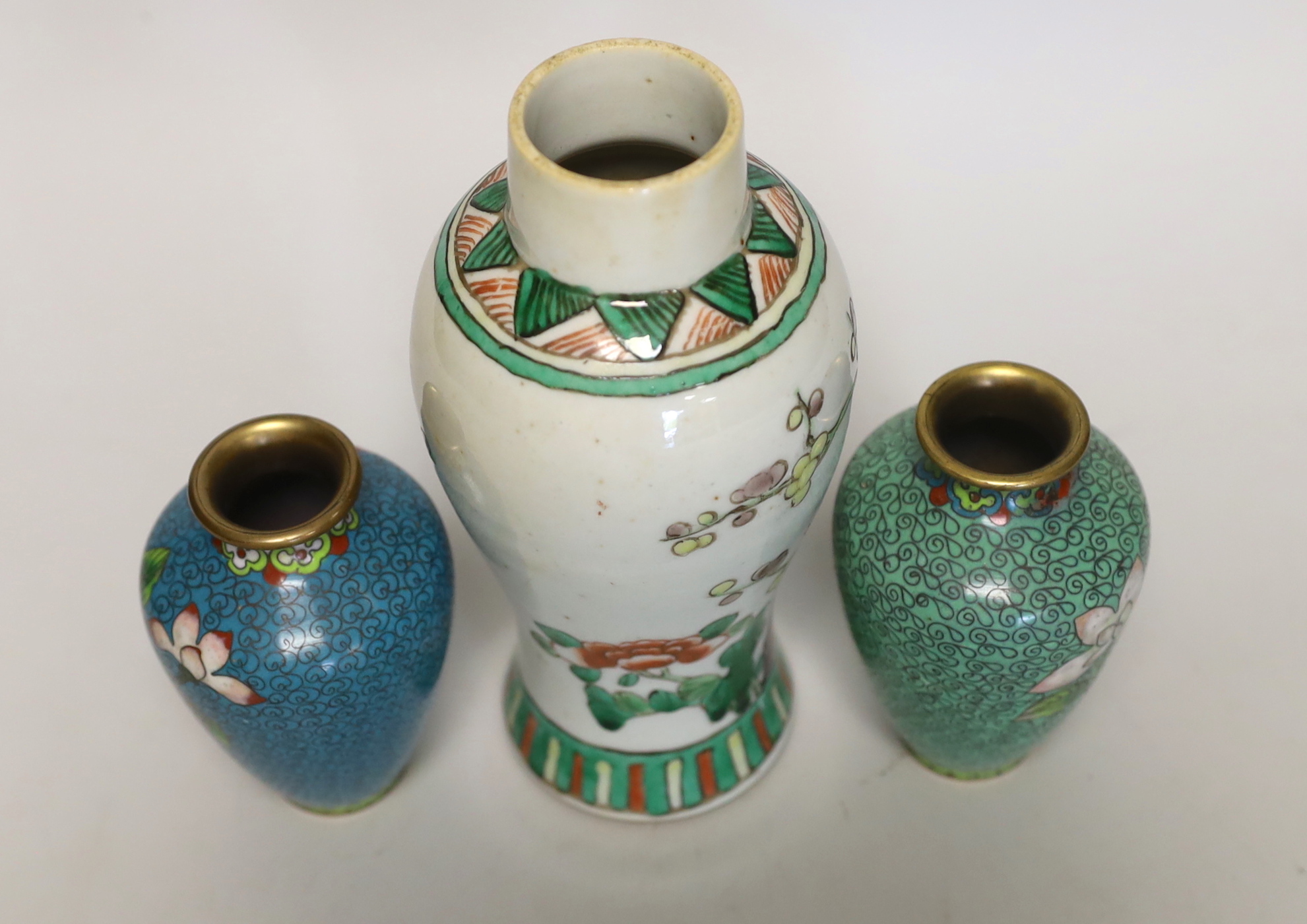 A Chinese famille verte small vase and a pair of cloisonné enamel vases, tallest 18cm high